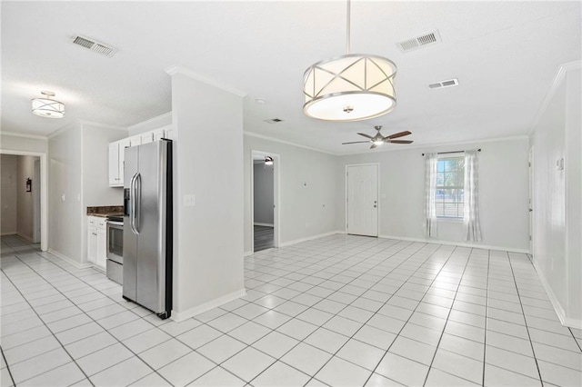 kitchen with white cabinetry, stainless steel fridge, and light tile patterned flooring