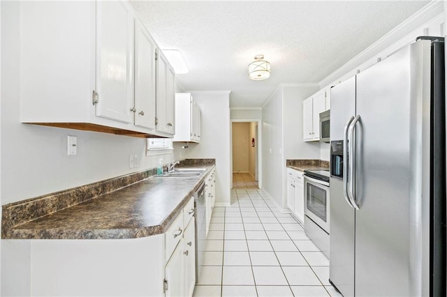 kitchen featuring sink, appliances with stainless steel finishes, light tile patterned floors, crown molding, and white cabinets