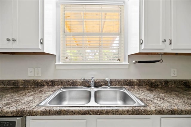 kitchen with sink and white cabinetry