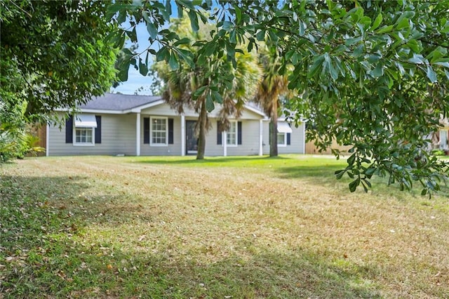 rear view of property with a lawn