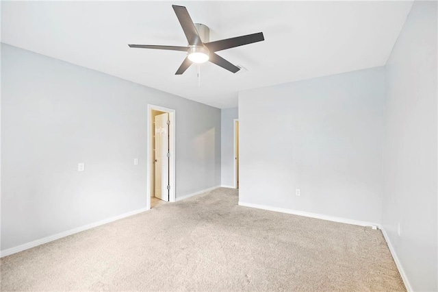 spare room with ceiling fan and light carpet