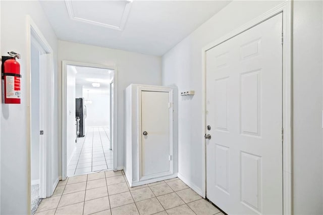 corridor featuring light tile patterned floors