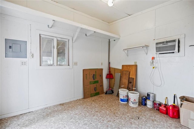 garage with electric panel and a wall mounted air conditioner