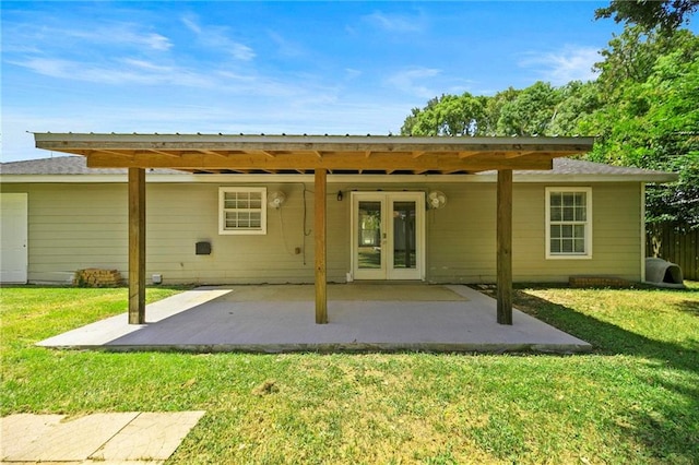 rear view of property with a patio area, a yard, and french doors