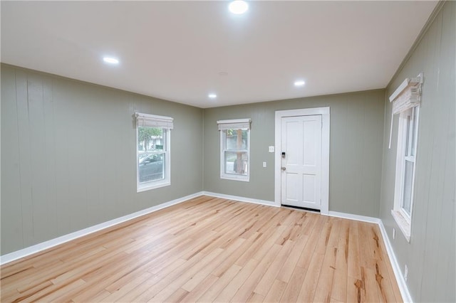 interior space featuring wood walls and light hardwood / wood-style flooring