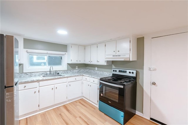 kitchen featuring light hardwood / wood-style floors, stainless steel refrigerator, white cabinetry, sink, and black range with electric cooktop