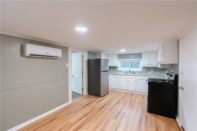 kitchen featuring white cabinets, black range with electric cooktop, light hardwood / wood-style flooring, an AC wall unit, and stainless steel fridge