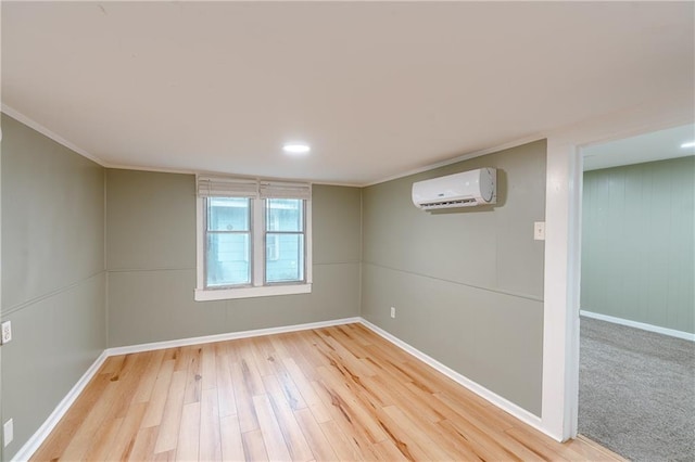 basement with a wall unit AC, wood-type flooring, and crown molding