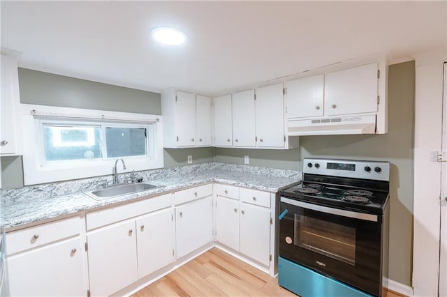 kitchen featuring light hardwood / wood-style floors, white cabinets, sink, stainless steel range with electric cooktop, and light stone countertops