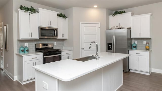 10676 Relic Rd N, Mobile, AL 36608 - kitchen with appliances with stainless steel finishes, a sink, dark wood finished floors, backsplash, and recessed lighting
