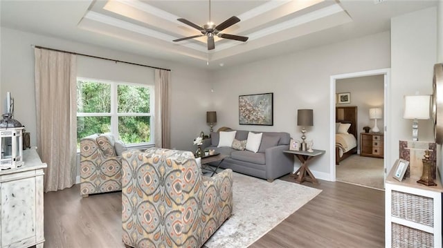 10676 Relic Rd N, Mobile, AL 36608 - living room featuring a raised ceiling, ceiling fan, wood finished floors, and baseboards