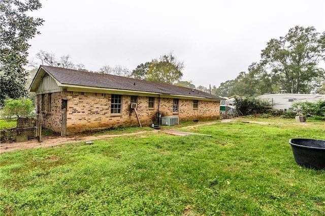 back of property featuring a yard and cooling unit