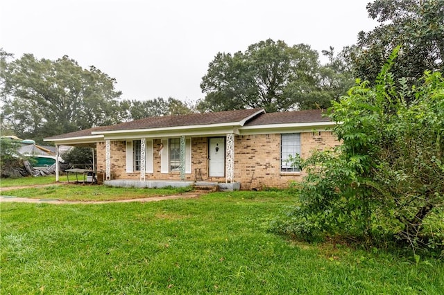 ranch-style house with covered porch and a front lawn