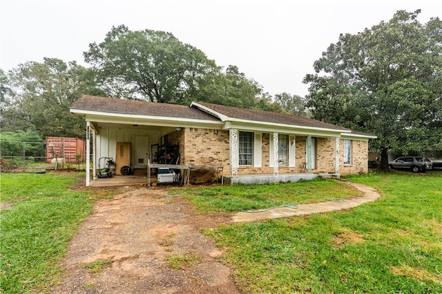 view of front of house with a front yard, a porch, and a carport