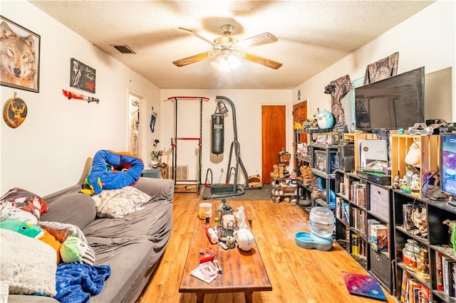 interior space with wood-type flooring, a textured ceiling, and ceiling fan