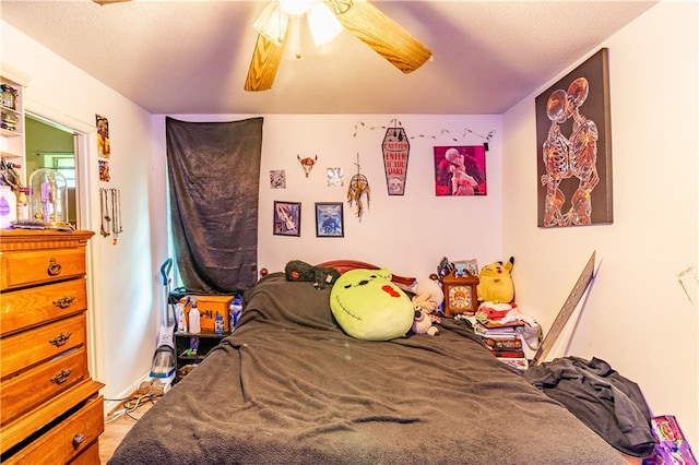 bedroom with a textured ceiling and ceiling fan