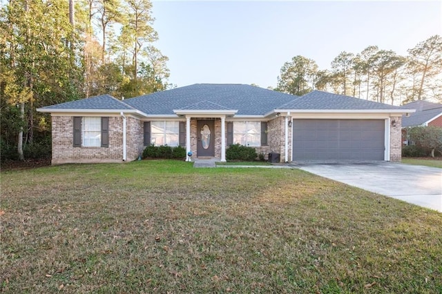 single story home featuring a garage and a front lawn