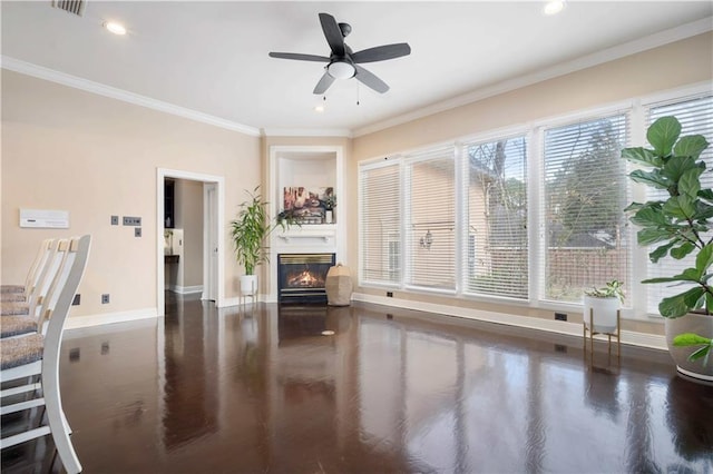 unfurnished living room featuring a glass covered fireplace, baseboards, and ornamental molding