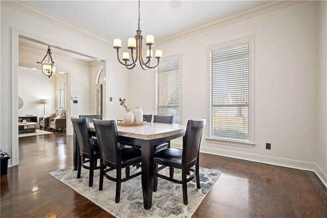 dining room with crown molding, dark wood-style floors, baseboards, and a chandelier