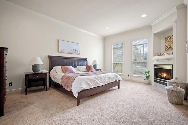 bedroom with baseboards, carpet floors, recessed lighting, ornamental molding, and a glass covered fireplace