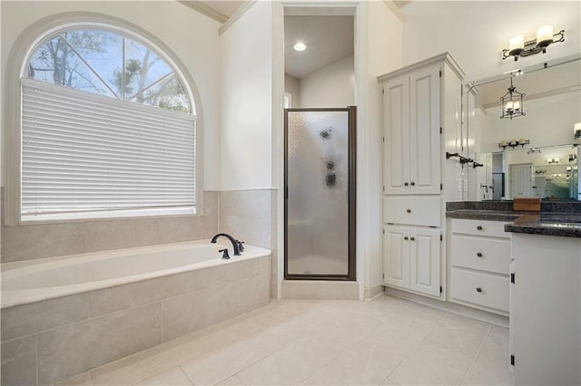 full bathroom with vanity, a garden tub, a shower stall, and tile patterned flooring