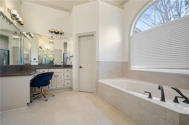 bathroom with tile patterned flooring, vanity, crown molding, and a garden tub