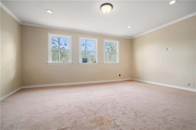 empty room with ornamental molding, recessed lighting, baseboards, and light carpet