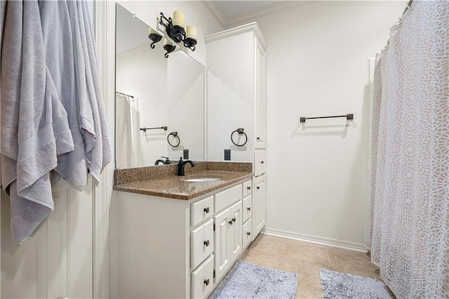 full bath with vanity, crown molding, baseboards, and tile patterned floors