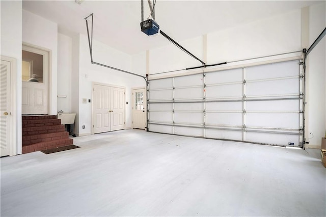 garage featuring a garage door opener and a sink