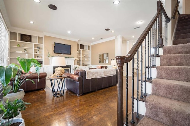 living area with stairway, visible vents, recessed lighting, ornamental molding, and dark wood-type flooring