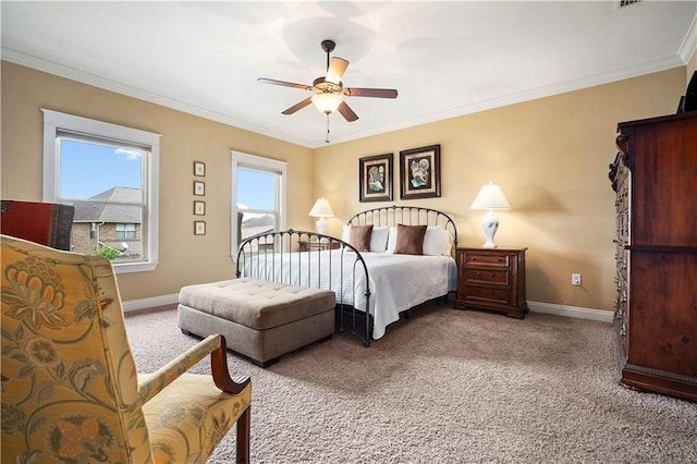 carpeted bedroom featuring ornamental molding, a ceiling fan, and baseboards
