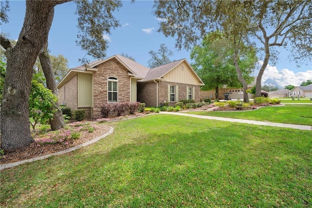 single story home with brick siding, a front yard, and stone siding