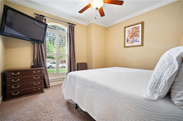 bedroom with crown molding, a ceiling fan, and carpet flooring