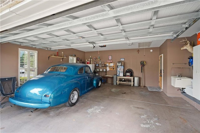 garage with a sink and a garage door opener