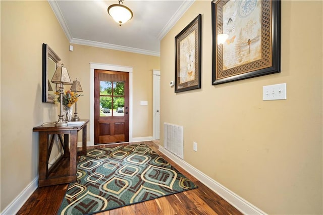 doorway featuring ornamental molding, visible vents, baseboards, and dark wood finished floors
