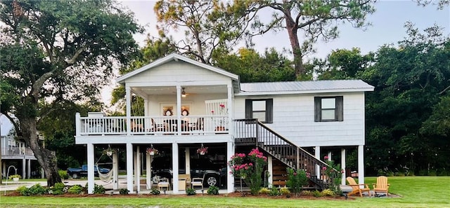 2026 Norman Ln, Gulf Shores, AL 36542 - back of property featuring a yard, metal roof, a ceiling fan, and stairway