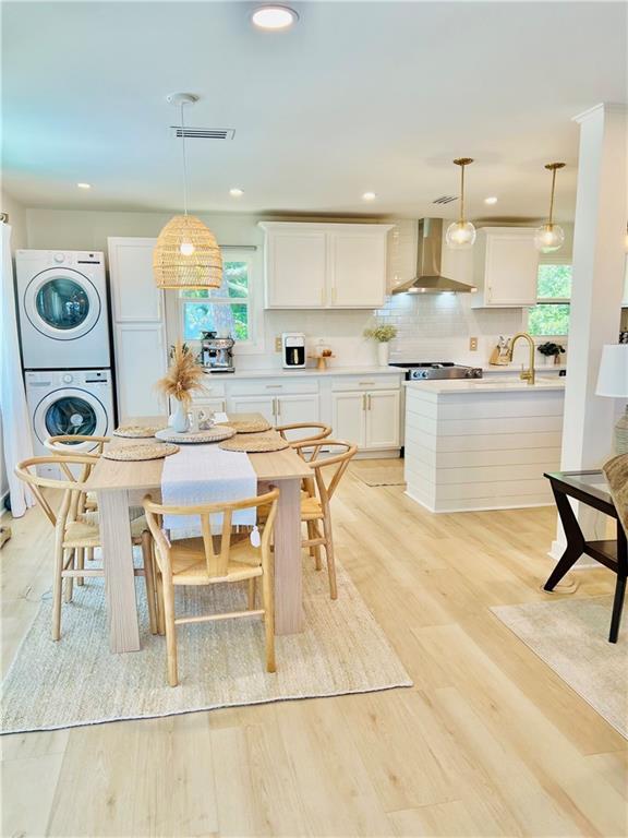 2026 Norman Ln, Gulf Shores, AL 36542 - dining room featuring stacked washer / dryer, light wood-type flooring, visible vents, and recessed lighting