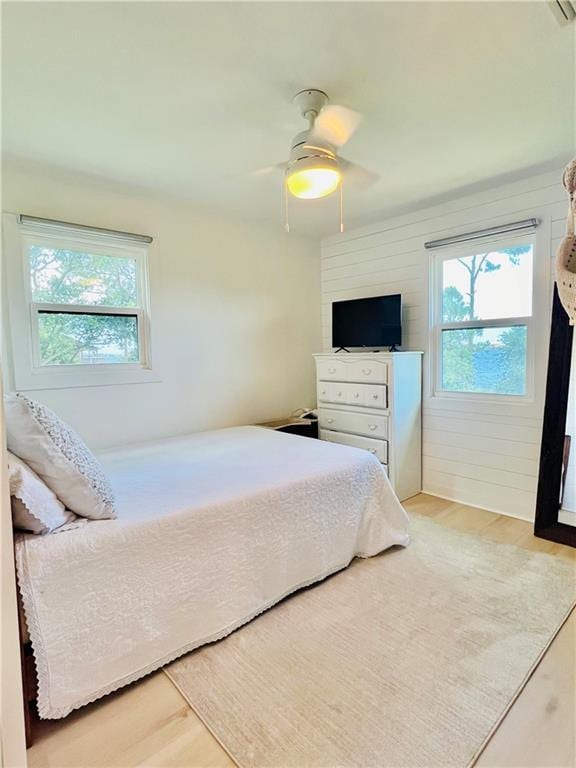 2026 Norman Ln, Gulf Shores, AL 36542 - bedroom featuring ceiling fan, multiple windows, and wood finished floors