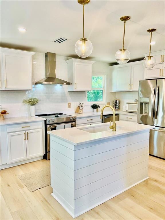 2026 Norman Ln, Gulf Shores, AL 36542 - kitchen featuring tasteful backsplash, wall chimney range hood, appliances with stainless steel finishes, light countertops, and a sink