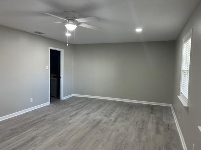 spare room featuring light hardwood / wood-style floors and ceiling fan