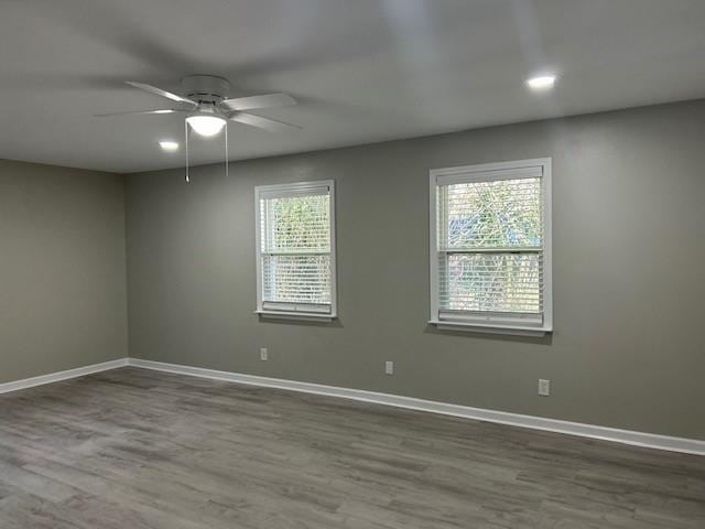 empty room featuring ceiling fan and hardwood / wood-style floors