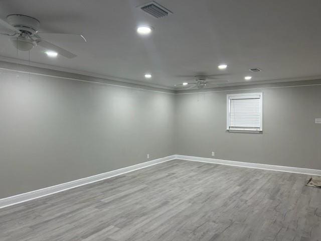 empty room featuring light hardwood / wood-style flooring, ceiling fan, and ornamental molding