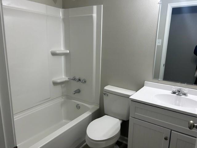 full bathroom with  shower combination, toilet, and vanity