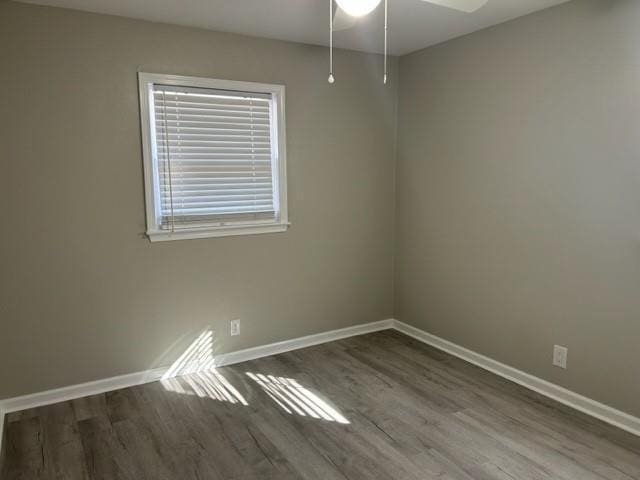 unfurnished room featuring ceiling fan and dark wood-type flooring