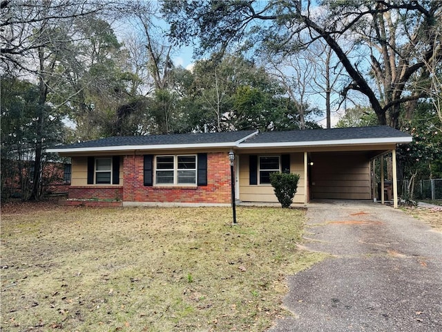 ranch-style house featuring a carport and a front yard