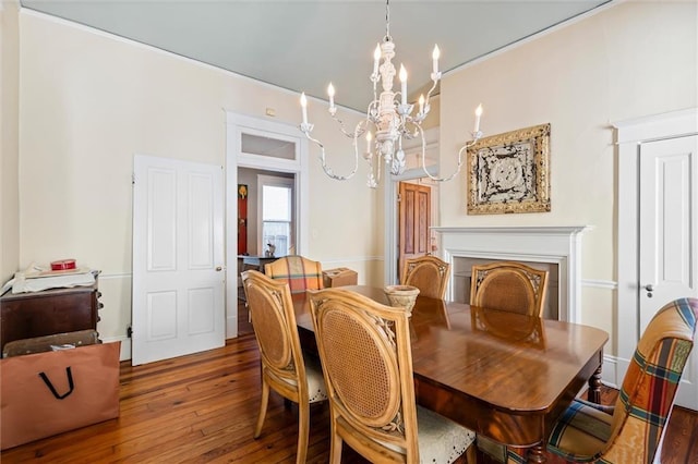 dining space with dark hardwood / wood-style flooring and a notable chandelier