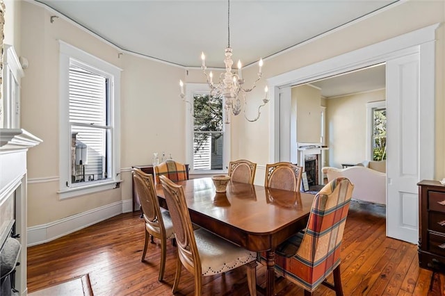 dining room featuring dark hardwood / wood-style floors, ornamental molding, and a chandelier