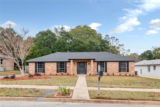 ranch-style house featuring central air condition unit and a front lawn