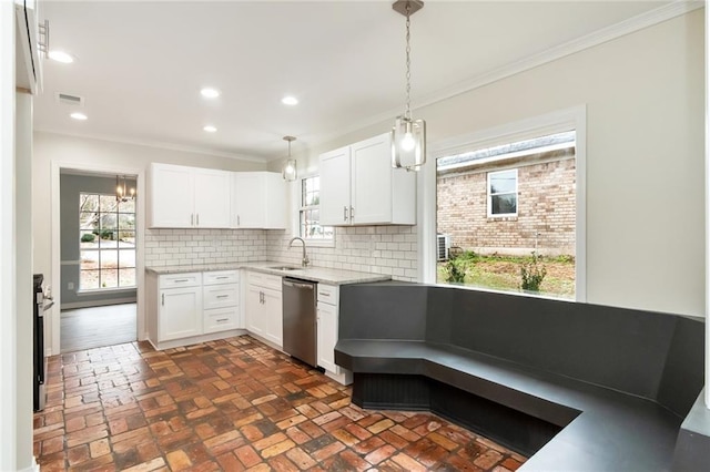 kitchen featuring dishwasher, sink, tasteful backsplash, decorative light fixtures, and white cabinetry