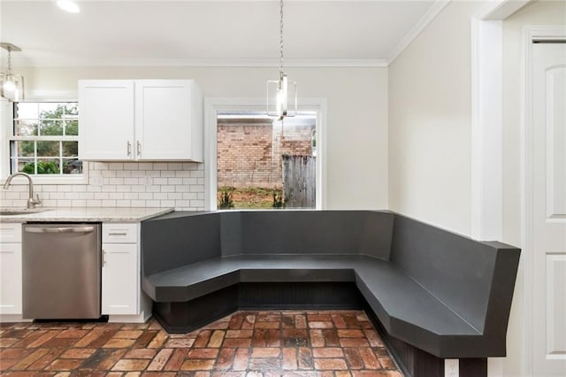 kitchen featuring dishwasher, pendant lighting, backsplash, and white cabinetry